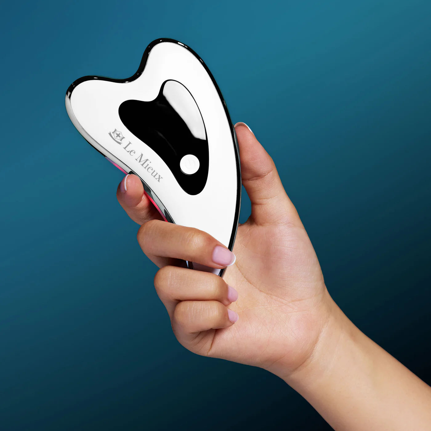 Model demonstrating sculpting strokes with Le Mieux Gua Sha ThermaLift to tone and define facial contours.